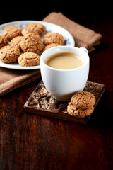 Cup of coffee on wooden background. Close up.