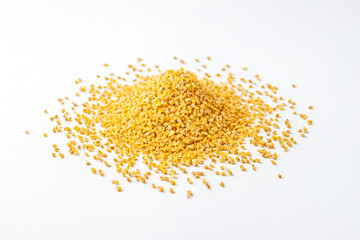 Dried osmanthus flowers scattered on a white surface