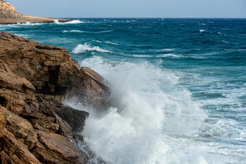 waves crashing on rocky coast. Windy weather , Powerful sea waves braking on rocks