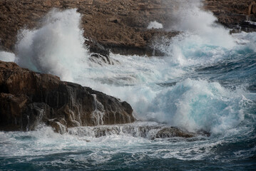 waves crashing on rocky coast. Windy weather , Powerful sea waves braking on rocks
