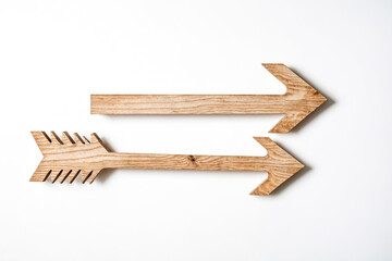 Two wooden arrows pointing right on white background