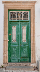 Pano Lefkara village, Larnaka region, Cyprus-May 24, 2024: Stone houses, white walls, narrow cobbled lanes, doors, windows, flowers, flowerpots, billboards, as seen in the village narrow streets 