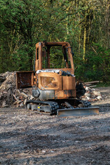 Fototapeta premium Burnt out construction digger by thieves.