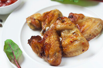 Fried chicken wings in a plate on the table