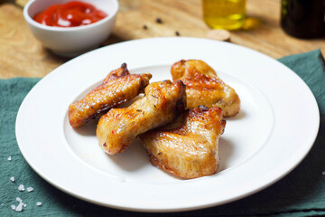 Fried chicken wings in a plate on the table