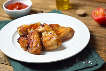 Fried chicken wings in a plate on the table