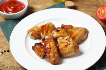 Fried chicken wings in a plate on the table