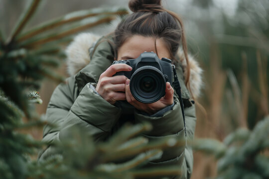 Attractive professional photographer woman taking a photo holding DSLR camera