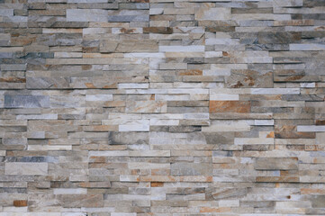 Brown stone wall with bricks