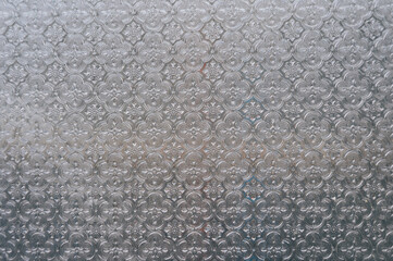 Glass surface with intricate floral design pattern