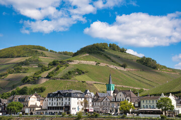 Village nestled beside a hill with a slope alongside, Rhine, Germany