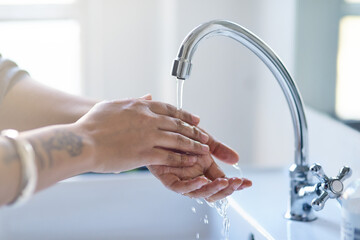 Hands, person and water in bathroom for hygiene, cleaning and protection from germs at home. Covid...