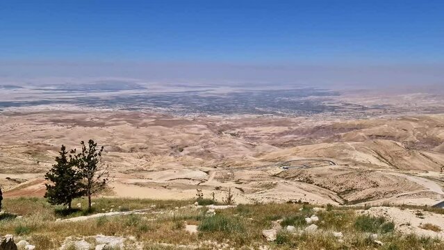 View from highpoint of Mount Nebo with some green trees and plants on a sunny day in Jordan