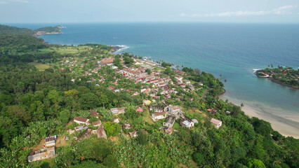 Beach with lush palm trees and crystal-clear water, south of sao tome
