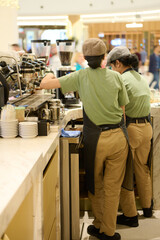 three people are preparing food on the counter in a restaurant