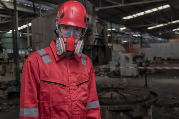 Portrait worker in protective helmet and mask. Workers wear protection suit checking chemical in...