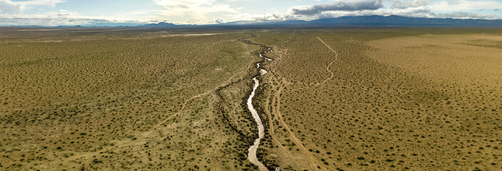 View of a river separating a valley with mountains in the background
