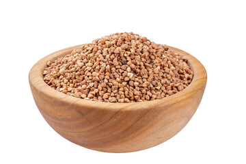 Green buckwheat grain in wooden bowl isolated on white background. File contains clipping path.