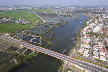 Aerial view of a bridge over Thu Bon river on sunny day. Hoi An, Vietnam.