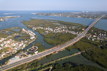Aerial view of Thu Bon river delta and the bridge over the river on sunny day. Hoi An, Vietnam.