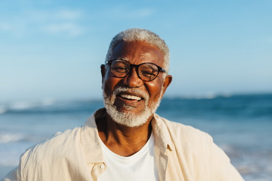 Happy older African American man smiling at the beach