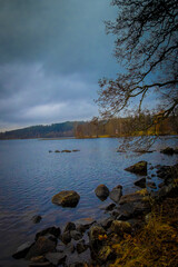 Dark cloud casts a shimmering reflection on water under a gloomy sky in Ludvika town, Sweden