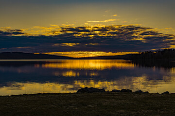 Sunset over Lake Vasman in Ludvika County, Sweden and the colorful sky with clouds
