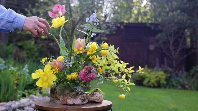 summer floral arrangement in a ceramic vase with kenzan of garden flowers, bouquet of seasonal flowers in the garden