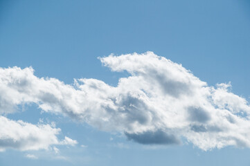 Fluffy clouds in a clear blue sky