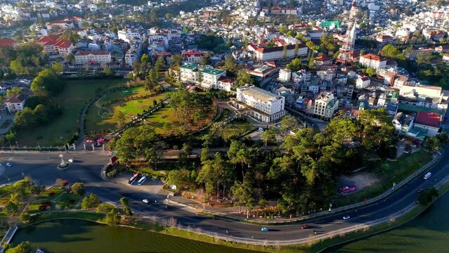 Aerial view by drone urban of Dalat city, Vietnam, with mountains topographic street with downhill, uphill, old house in ancient france architecture as Con Ga or Rooster church at foggy morning