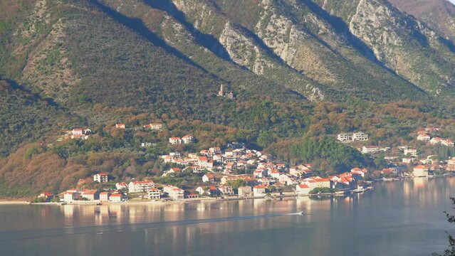 View of the small town of Prcanj along the Bay of Kotor on a sunny day, Montenegro