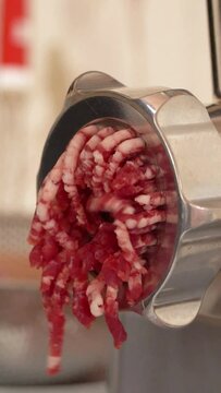 Meat grinder raw ground beef minced butcher shop close up vertical video 