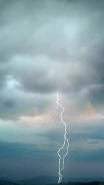 Lightning bolt strike dark clouds storm vertical video