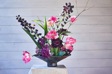 summer floral arrangement in a ceramic vase with kenzan of garden flowers, bouquet of seasonal...