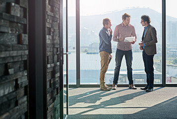 Business people, men and collaboration with document for planning by window of office for b2b...