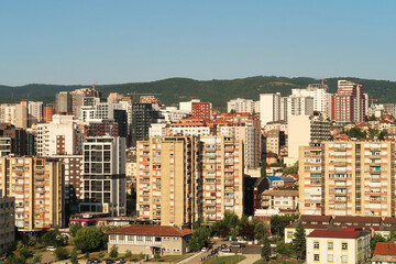 Naklejka premium View from the bell tower of the Cathedral of Saint, St. Mother Theresa onto socialist, brutalist concrete panel, multi-story, high-rise, apartment blocks, buildings, Prishtina, Pristina, Kosovo
