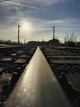 Sun shining on empty railroad tracks