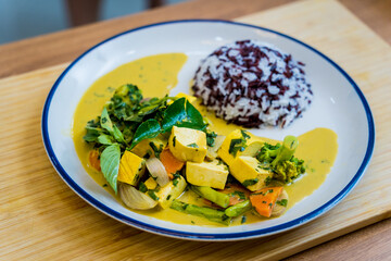 Traditional vegetable green curry with herbs and steamed rice