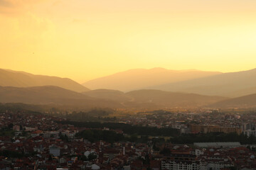 View from the Prizren Fortress onto the city and its surrounding landscape at sunset, the highway road can be seen in the far distance, Prizren, Kosovo