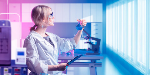 Woman medic in laboratory. Doctor with test tube in his hand. Doctor studies reagents. Medical...