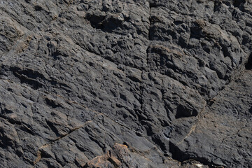 Stone texture worn by the wind and the sea of ​​the coast located on a wild beach.