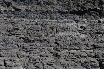 Stone texture worn by the wind and the sea of ​​the coast located on a wild beach.