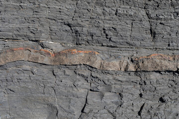 Stone texture worn by the wind and the sea of ​​the coast located on a wild beach.