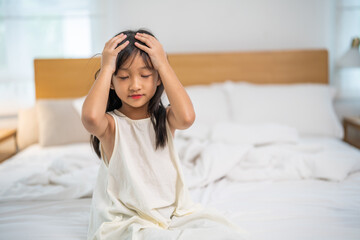 Portrait of sick depressed unhappy child girl touching on head feel suffering head ache pain flu...