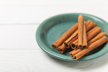 Cinnamon sticks on a textured wooden background. Cinnamon roll. Spicy spice for baking, desserts and drinks. Fragrant ground cinnamon. cinnamon powder Close-up. Place for text. copy space