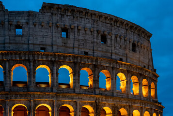 the colosseum in rome is lit up at night