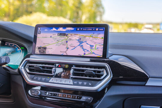 Close-up view of the navigation panel displaying the route of the BMW iX3m electric car while driving on the highway. Sweden.