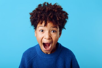 expression of astonishment young african american boy making a surprised face against a vibrant...