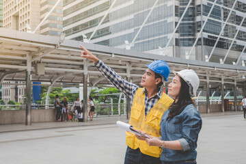 Banner Two engineer women businessman look at blueprint architecture building contractor. Team Engineer holding project planing partner teamwork. Two woman man meeting teamwork with copy space