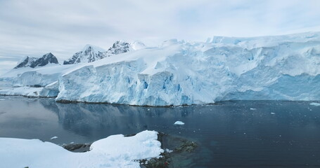 Global Warming and Climate Change - Giant glacier towers in Antarctica. Aerial drone view arctic...
